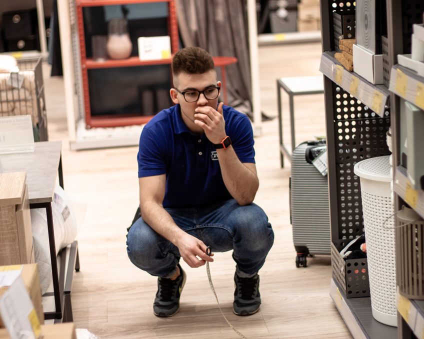 Deputy Store Manager Mikolaj Placzek measures if everything is were it should be