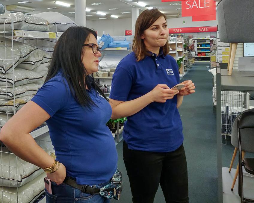 Store Manager Ewa Adamska and Alia evaluate the store's visual appearance 