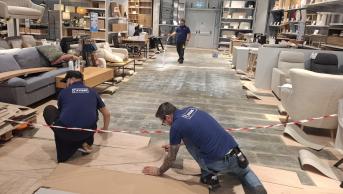 The three Romanian E-Team Members (Alex, Cosmin and Daniel) preparing a store.